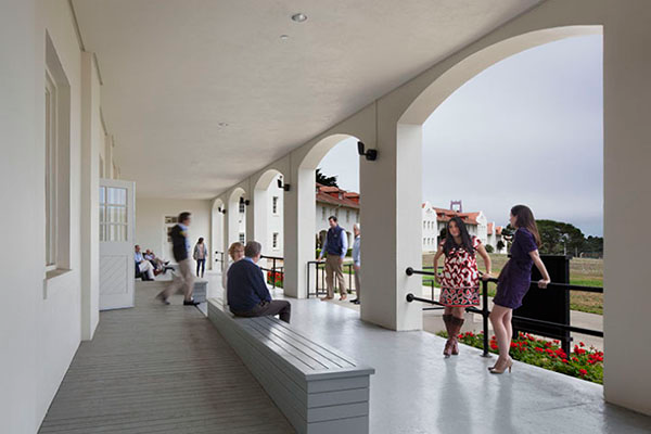 Event attendees socializing on the building's porch